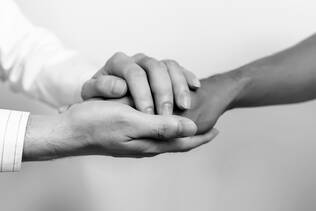 Doctor holding patients hand